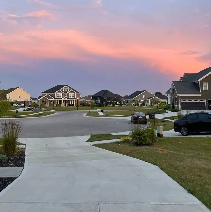 Modern suburban neighborhood with single-family homes at sunset